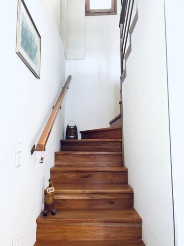 a staircase with wooden floors and white walls at House of light in Évdhilos