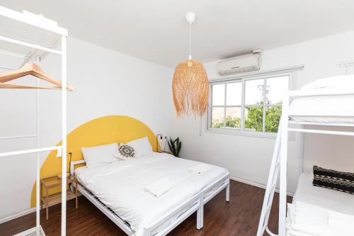 a bedroom with a bed and two bunk beds at The White Hill Guesthouse in Yeroẖam