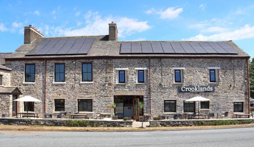 a building with solar panels on the roof at Crooklands Hotel in Crooklands