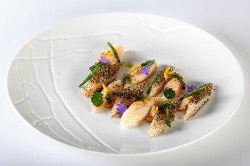 a white plate with some food on it at Hotel Corsica & Spa Serena in Calvi