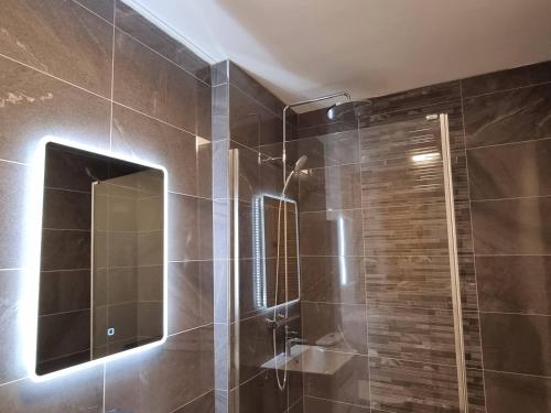 a bathroom with a glass shower with a mirror at The Forge by Cliftonvalley Apartments in Bristol