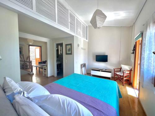 a bedroom with a large bed and a living room at House of light in Évdhilos