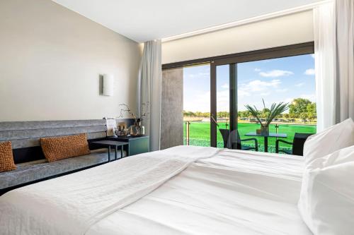 a bedroom with a large white bed and a large window at Ringenäs Hotell & Konferens in Halmstad