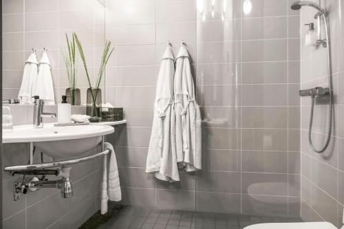 a bathroom with a shower and a sink and a toilet at Ringenäs Hotell & Konferens in Halmstad