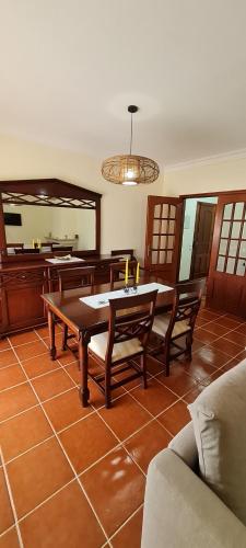 a living room with a table and chairs and a mirror at Lovely Modern Duplex 3 Bedroom Flat in Quiet Area in Tavarede