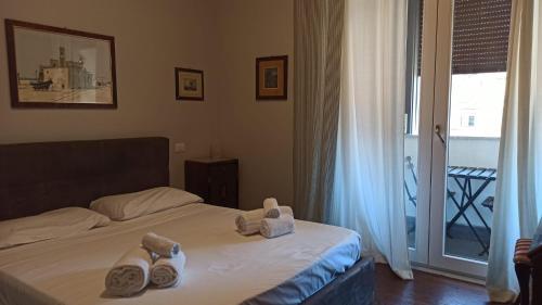 a bedroom with a bed with towels on it at My Way - Suite - Rooms - Palazzo San Matteo in Palermo