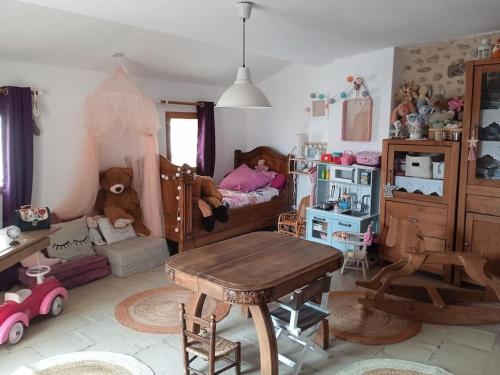 a childs bedroom with a bed with a child in it at Grande maison coeur de village piscine jacuzzi in Maureillas