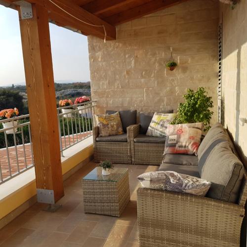 a porch with a couch and a table on a balcony at Villa Susann in Šibenik