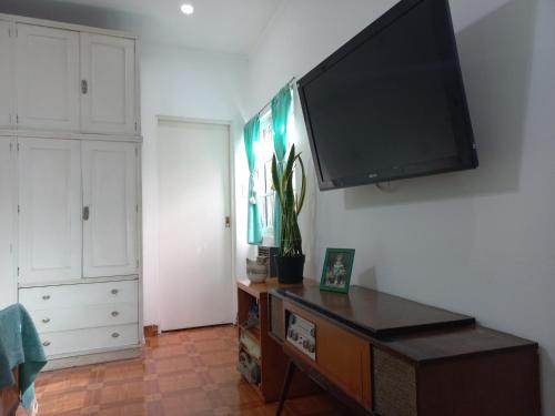 a living room with a flat screen tv on a wall at Casa Centrica con garage in Mercedes