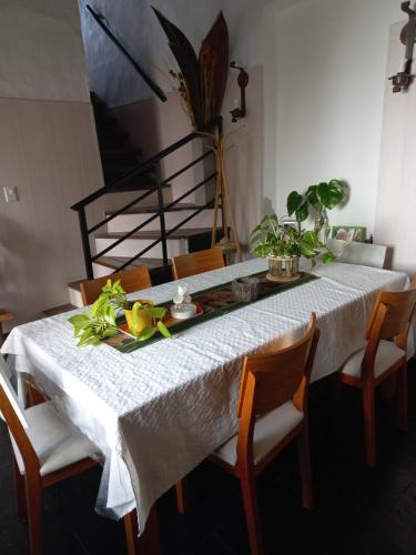 a dining room table with a white table cloth at Casa Centrica con garage in Mercedes