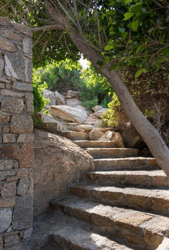 a set of stone stairs in a stone wall at Etesians Suites & Villas in Super Paradise Beach