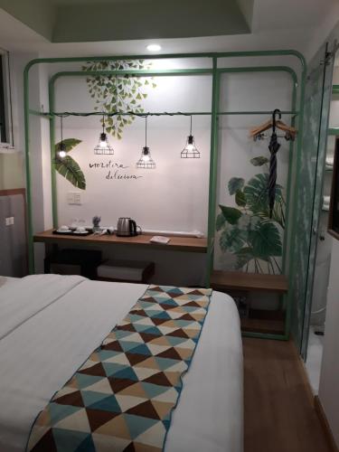 a bedroom with a bed and a desk with plants at Ngoc Khanh hotel in Nha Trang