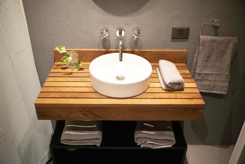 a bathroom with a sink on a wooden counter at Primavera Suites in Buenos Aires