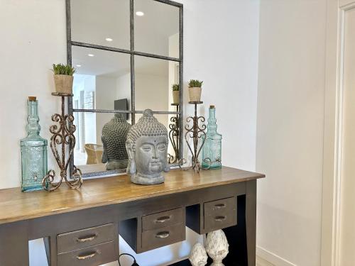 a dressing table with a mirror and a statue at Loft 18 Beachfront Marbella Center in Marbella