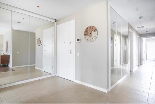 a hallway with glass walls and a clock on a wall at 4 bedroom rental unit with pool/middle of Bursa in Nilüfer