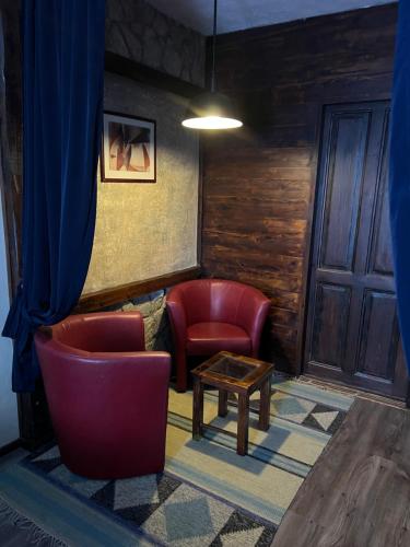 a living room with two chairs and a table at Villa Sagan in Zamárdi