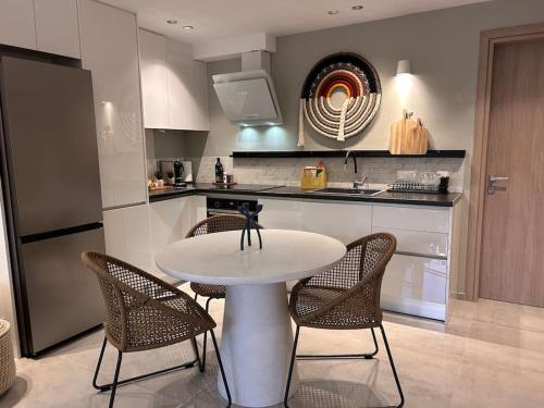a kitchen with a table and chairs in a kitchen at O live Kalamata in Kalamata