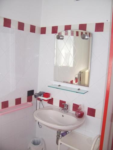 a bathroom with a sink and a mirror at B&b Margherita in Calasetta