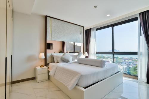 a bedroom with a white bed with a large window at AO503 - Penthouse Amazing View 2bedrooms 3Beds 300m Walk To Ao Nang Beeach in Ao Nang Beach