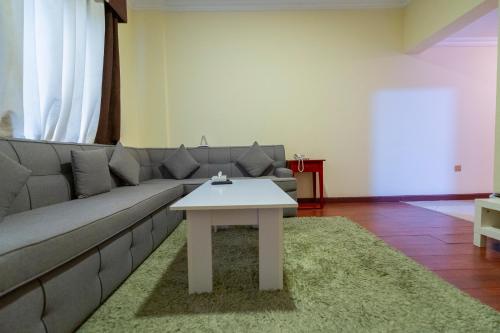 a living room with a couch and a table at Majestic Hotel in Manama