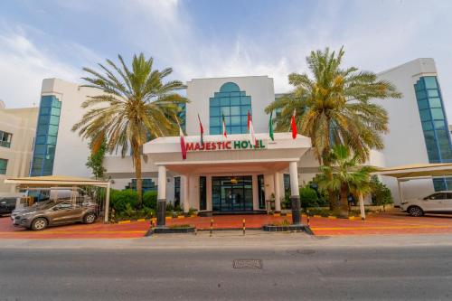 a building with a car parked in front of it at Majestic Hotel in Manama