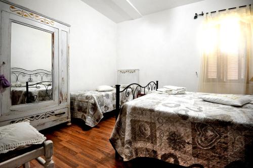 a bedroom with two beds and a large mirror at COUNTRY HOUSE in Sezze