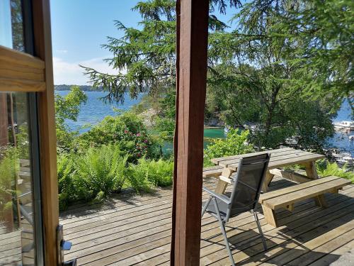 a deck with a picnic table and a bench at Fanafjorden Cabins in Bergen