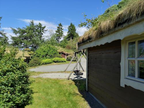 a building with a grass roof on the side of it at Fanafjorden Cabins in Bergen