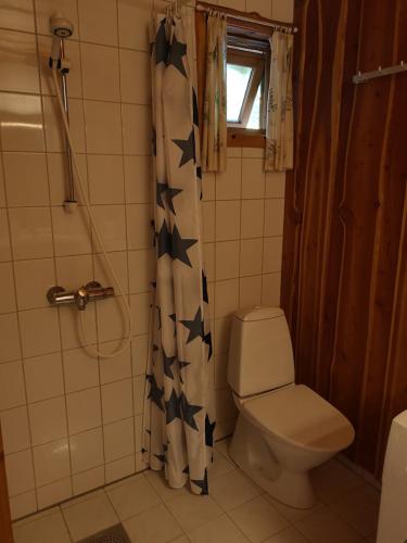 baño con aseo y cortina de ducha con estrellas en Fanafjorden Cabins en Bergen