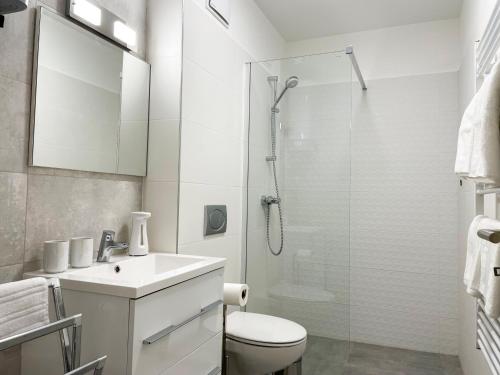 a bathroom with a shower and a toilet and a sink at Aqua Apartman in Zalakaros