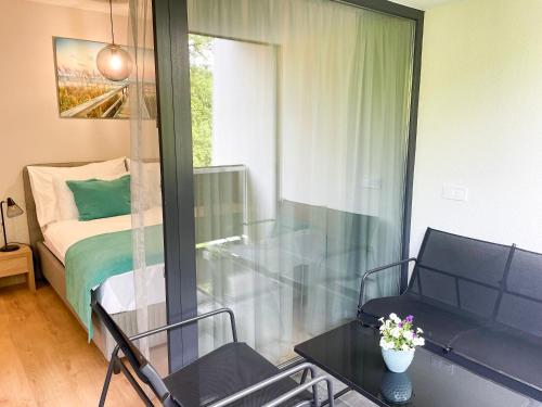 a room with a bed and a table and chairs at Aqua Apartman in Zalakaros