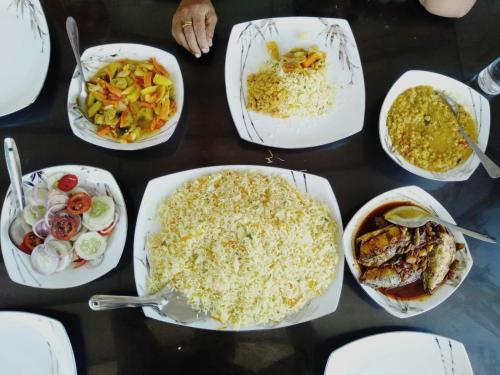 a table topped with plates of food and bowls of food at Thalalla Ocean View in Dickwella