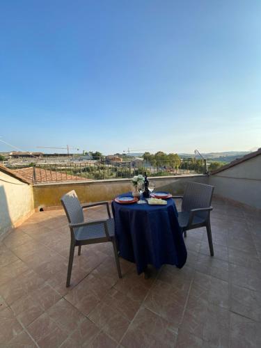 a table and chairs on a balcony with a view at Home Ilardo in Campobello di Licata