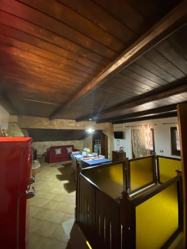 a living room with a wooden ceiling and a table at Home Ilardo in Campobello di Licata