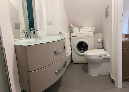 a bathroom with a sink and a washing machine at Magici ricordi-Bordighera in Bordighera