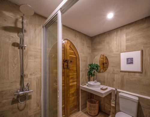 een badkamer met een douche, een toilet en een wastafel bij ภูคานาน่าน รีสอร์ท 