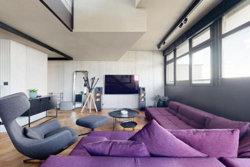 a living room with purple furniture and a purple couch at Štýlový loft s ohromnou terasou in Bratislava