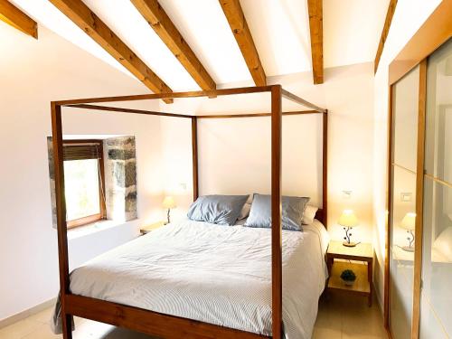 a bedroom with a canopy bed and a window at Casona Molinos del Agua in Arnuero