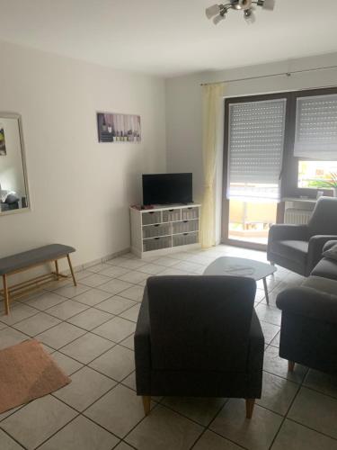 a living room with a couch and a tv at Ferienhaus Lönartz-Thielmann in Ernst