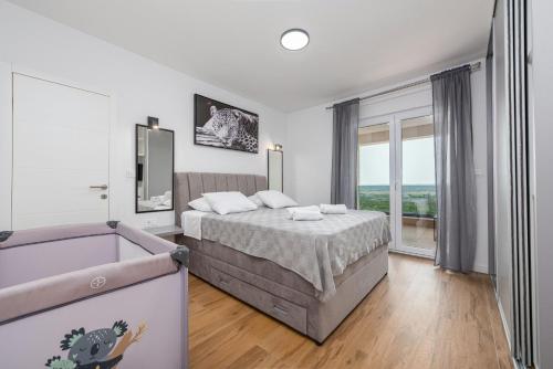 a bedroom with a bed and a tub in it at Vila Katarina ZadarVillas in Tinj