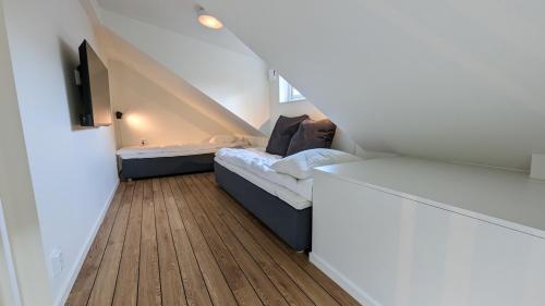 a small room with two beds and a staircase at Dragsö Camping & Stugby in Karlskrona