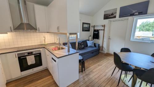 a kitchen and living room with a table and a couch at Dragsö Camping & Stugby in Karlskrona