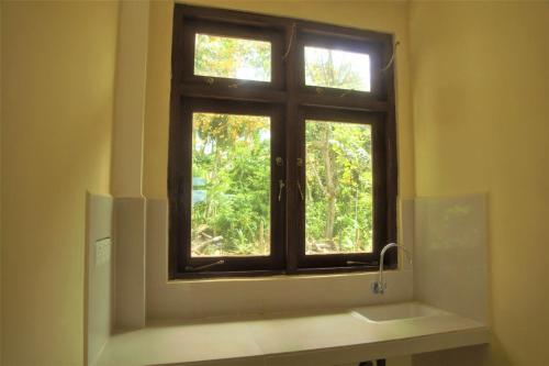 a window in a bathroom with a sink at Thalalla Ocean View in Dickwella