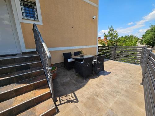 a patio with a table and chairs on a house at Residence Gordana in Selce