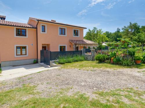 a house with a fence and a yard at Holiday Home Pahari by Rent Istria in Roč