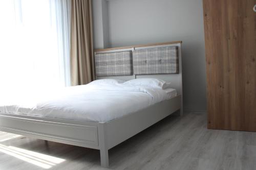 a white bed in a room with a window at Dolce Bella Suites in Trabzon