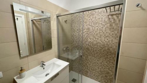 y baño con lavabo y ducha con espejo. en Central Apartment in La Laguna, en La Laguna