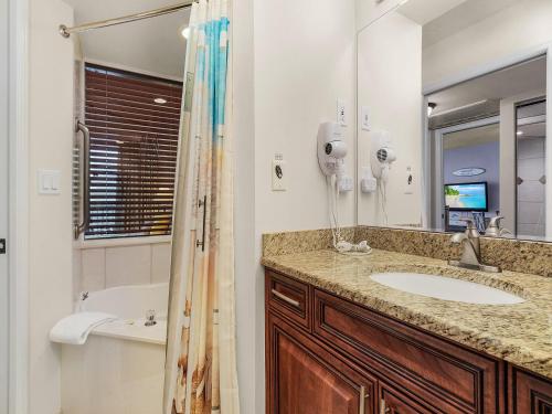 a bathroom with a sink and a tub and a mirror at Lovers Key Resort 503 - Fort Myers in Fort Myers Beach