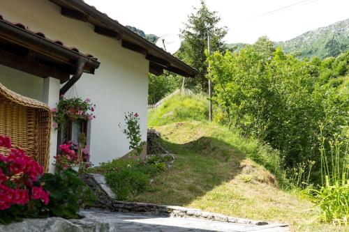 a house with flowers on the side of it at Country house At Peskar`s in Podbrdo