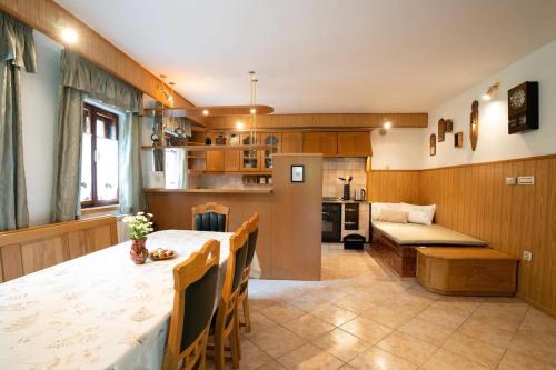 a kitchen and dining room with a table and chairs at Country house At Peskar`s in Podbrdo